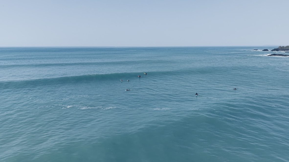 Surfers in the bay at Spekes Mill